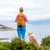 Woman hiking walking with dog on seaside trail stock photo © blasbike