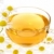 Cup of chamomile tea over white background stock photo © brozova