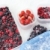Plastic containers of frozen mixed berries in snow - red currant, cranberry, raspberry, blackberry,  stock photo © brozova