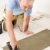 Home improvement, renovation - handyman laying tile stock photo © CandyboxPhoto