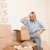 Moving house: Young woman unpacking box stock photo © CandyboxPhoto