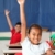 Two smiling young school children arms raised in class stock photo © darrinhenry