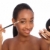 African american woman using eye shadow brush stock photo © darrinhenry