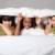 Sleepover party fun teenage girls laughing in bed stock photo © darrinhenry