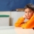 Serious school boy 10 deep in thought at classroom desk stock photo © darrinhenry