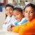 Three smiling primary school friends sitting together in class stock photo © darrinhenry