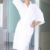 Smiling woman standing in white bathrobe stock photo © dash
