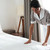 Maid setting up white bed sheet in hotel room stock photo © deandrobot