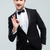 Smiling young man in tuxedo with bowtie showing ok sign stock photo © deandrobot