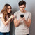 Portrait of a young couple standing with mobile phone stock photo © deandrobot
