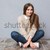 Happy excited young woman sitting with legs crossed stock photo © deandrobot