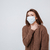 Woman in sweater and medical mask holding her neck stock photo © deandrobot