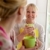 Mother and daughter talking, drinking coffee in kitchen stock photo © diego_cervo