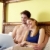 young couple lying on bed with pc stock photo © diego_cervo