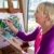 Happy elderly woman painting for fun at home stock photo © diego_cervo