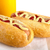 Hotdog with bottle of mustard and ketchup on wooden desk stock photo © dla4