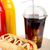 Hotdog with cola and bottle of mustard and ketchup on wooden desk stock photo © dla4