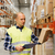 man with clipboard in safety vest at warehouse stock photo © dolgachov