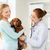 happy woman with dog and doctor at vet clinic stock photo © dolgachov