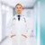 smiling male doctor in white coat with stethoscope stock photo © dolgachov