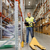 man with loader and clipboard at warehouse stock photo © dolgachov