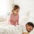 little girl waking her sleeping father up in bed stock photo © dolgachov