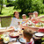 happy family having dinner or summer garden party stock photo © dolgachov
