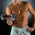 close up of young man with dumbbell stock photo © dolgachov