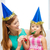 mother and daughter in blue hats with favor horns stock photo © dolgachov