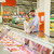 couple with shopping cart buying meat at grocery stock photo © dolgachov