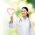 smiling female doctor pointing to heart stock photo © dolgachov