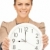 woman holding big clock stock photo © dolgachov