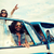 smiling young hippie friends over minivan car stock photo © dolgachov