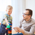 father and son playing with toy blocks at home stock photo © dolgachov