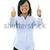 Smiling young woman giving thumbs up stock photo © elenaphoto