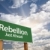 Rebellion Green Road Sign and Clouds stock photo © feverpitch