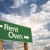 Rent, Own Green Road Sign Against Clouds stock photo © feverpitch