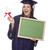 Female Graduate in Cap and Gown Holding Diploma,Blank Chalkboar stock photo © feverpitch