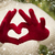 Woman Wearing Red Mittens Holding Out a Heart Hand Sign stock photo © feverpitch