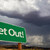 Get Out Green Road Sign and Stormy Clouds stock photo © feverpitch