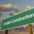 Under Construction Green Road Sign Over Clouds stock photo © feverpitch
