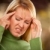 Grimacing Woman Suffering a Headache stock photo © feverpitch