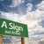 A Sign Green Road Sign Against Clouds stock photo © feverpitch