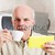 Grinning man holding digital reader and cup stock photo © Giulio_Fornasar