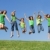happy group of mixed race kids at summer camp or school jumping stock photo © godfer
