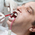 Man during teeth whitening process at the dentist office stock photo © gsermek