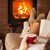 Woman enjoying free time by the fire - reading a book stock photo © ilona75