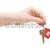 A key on a house key chain in a person's hand isolated on white  stock photo © inxti