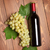 Red wine bottle and bunch of white grapes stock photo © karandaev