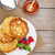 Pancakes with raspberry, blueberry, milk and honey syrup stock photo © karandaev
